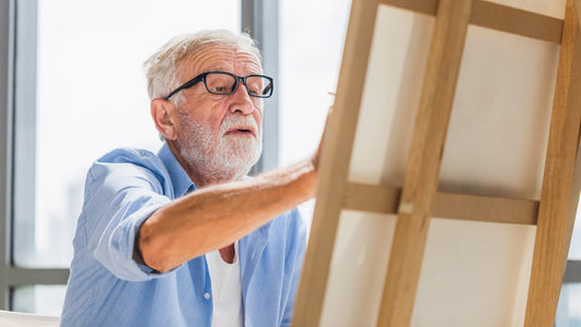 Man with white hair and beard painting - probiotics for parkinson's disease