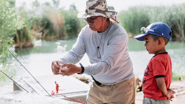 grandfather and grandson fishing to illustrate an article about probiotics and parkinson's disease