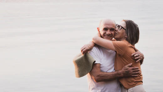Mature couple embracing at the shore of a lake. Do probiotics help with anxiety?